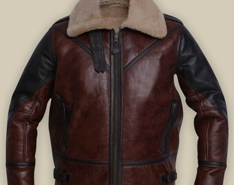 May include: A brown leather jacket with black leather sleeves and a shearling collar. The jacket has a zipper closure and two pockets on the front.