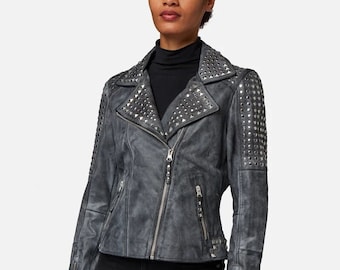 May include: A gray leather jacket with silver studs on the shoulders, collar, and front. The jacket has a zipper closure and two pockets on the front.