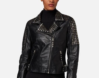 May include: A black leather jacket with silver studs on the shoulders, collar, and sleeves. The jacket has a zipper closure and a pointed collar.