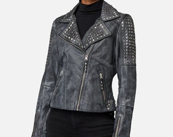 May include: A gray leather jacket with silver studs on the shoulders, collar, and sleeves. The jacket has a zipper closure and two pockets.