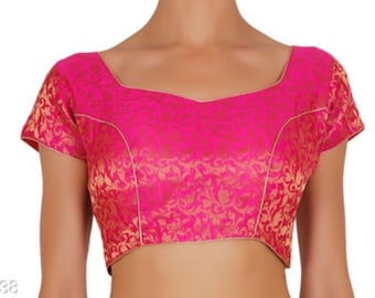 May include: A pink and gold brocade blouse with a square neckline and short sleeves.