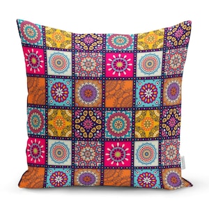 May include: A colourful throw pillow with a patchwork design featuring various shades of orange, yellow, pink, blue, and purple. The pillow is covered in intricate mandala patterns.