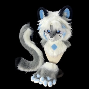 May include: A white and gray furry animal costume with blue accents. The costume includes a head, tail, and paws. The head has a white face with black spots and blue eyes.