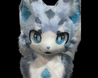 May include: A blue and white furry animal head with large blue eyes. The head is made of soft, plush fabric and has a diamond-shaped pattern on the chest.