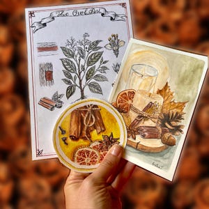 May include: A collection of three watercolor illustrations including a botanical print titled The Owl Post, a circular painting of cinnamon sticks and orange slices, and a rectangular painting of a candle with autumn leaves and pinecones.