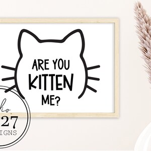 May include: Black and white printable wall art featuring a cat silhouette with the text "Are you kitten me?"