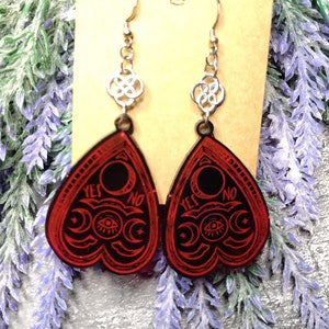 Dark red (almost black) Ouija earrings with bright red outlines. In addition, as a connection to the earhook, a knot