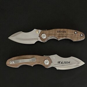 May include: Two pocket knives with wooden handles. The top knife has the name "Bryan" engraved on the handle, along with the word "Groomsman". The bottom knife has the date "18.6.2024" engraved on the handle.
