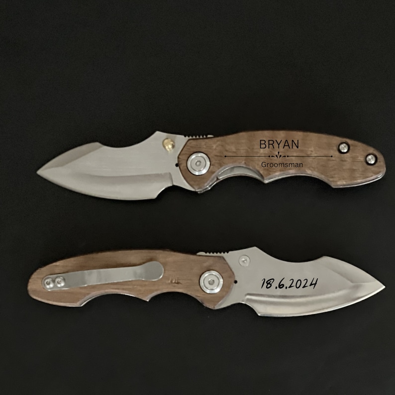 May include: Two pocket knives with wooden handles. The top knife has the name "Bryan" engraved on the handle, along with the word "Groomsman". The bottom knife has the date "18.6.2024" engraved on the handle.