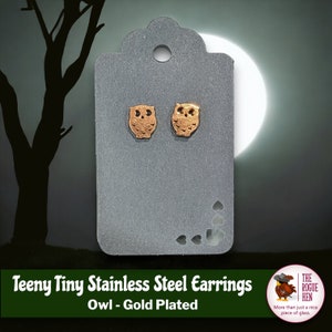 May include: A pair of gold-plated stainless steel earrings featuring a tiny owl design. Teeny Tiny Stainless Steel Earrings Owl - Gold Plated.