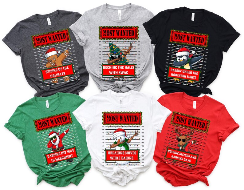 May include: A collection of Christmas-themed t-shirts. Each shirt features a "Most Wanted" design with a holiday character dabbing, such as a gingerbread man, Christmas tree, penguin, Santa, snowman, and reindeer. The shirts come in various colors.