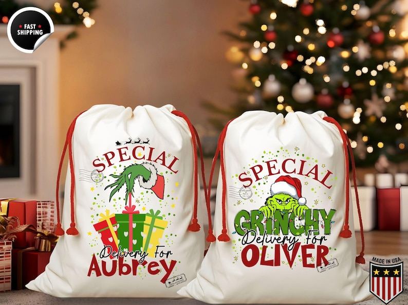 May include: Two white drawstring gift bags with red drawstrings. One bag features a Grinch design with the text "Special Delivery for Aubrey." The other bag has a Grinch design with the text "Special Grinchy Delivery for Oliver."
