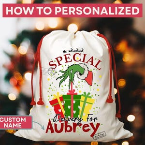 May include: A white Christmas gift bag with red drawstrings. The bag features a Grinch-themed design with the words "Special Delivery For Aubrey". The bag also has a red banner that says "How to Personalize".