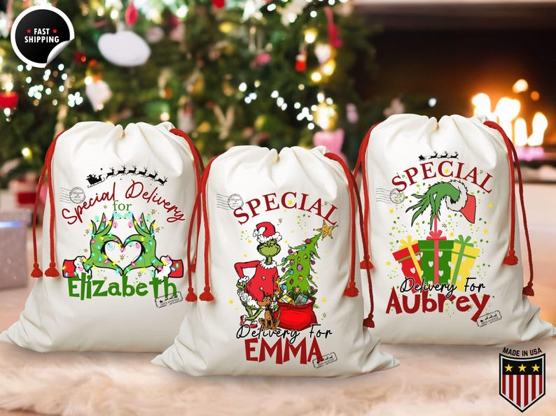 May include: Three white Christmas gift bags with red drawstrings. Each bag features a Grinch-themed design and the words "Special Delivery" with a name. One bag has a Grinch hand heart, another has the Grinch with a Christmas tree, and the last has the Grinch with gifts.