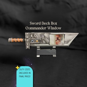 May include: A sword-shaped deck box featuring a metallic silver finish, an orange handle, and a clear display window containing a trading card. The text "Sword Deck Box Commander Window" is printed above the object in a serif font.