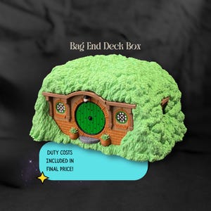 May include: A Bag End Deck Box featuring a textured green grassy exterior, a round green door with black studs, and brick-patterned walls. The structure includes two small round windows with white frames and a small light fixture above the door.