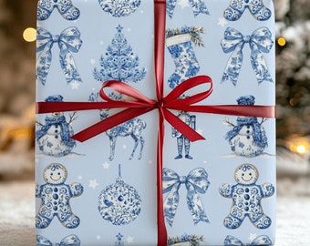 Puede incluir: Un regalo envuelto con papel de regalo azul claro con un patrón repetido de ilustraciones festivas en blanco y azul. Una cinta roja está atada alrededor del regalo. Las ilustraciones incluyen muñecos de nieve, lazos y árboles de Navidad.