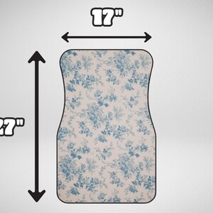 May include: A white and blue floral car floor mat measuring 17 inches wide and 27 inches long.