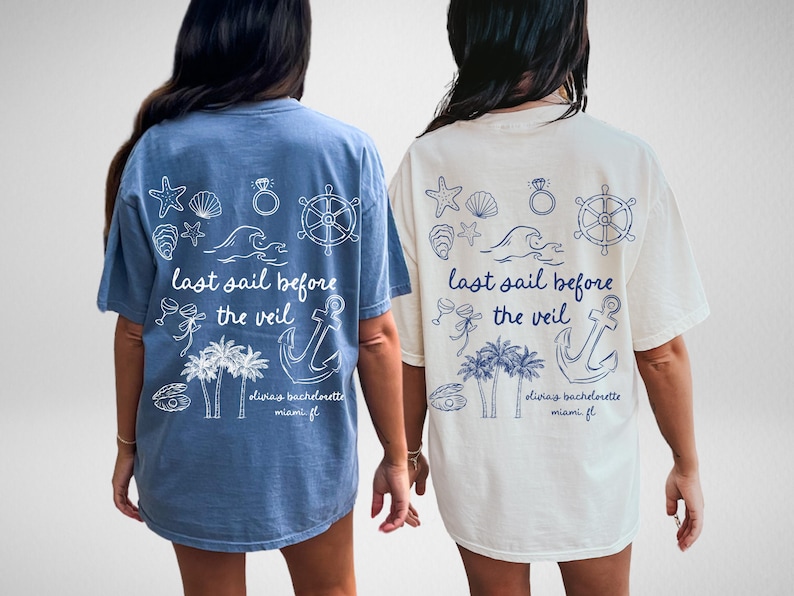 May include: Two light blue and white t-shirts with a nautical theme. The shirts have a graphic design with an anchor, palm trees, seashells, a ring, and a steering wheel. The text on the shirts reads "last sail before the veil" and "oliviay bachelorette miami fl".