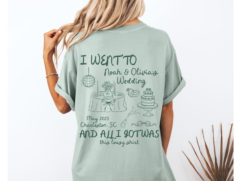 May include: A light green t-shirt with the text "I went to Noah & Olivia's Wedding May 2025 Charleston, SC and all I got was this lousy shirt". The shirt features a drawing of a wedding cake, a disco ball, and a wedding table setting.