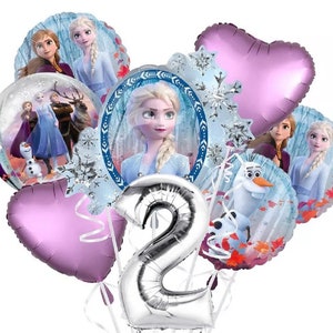 May include: A set of Frozen-themed party balloons featuring Elsa, Anna, Olaf, and Kristoff. The balloons are silver, blue, and purple, and include a large silver number 2 balloon.