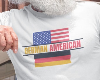 May include: White t-shirt with a graphic of the American and German flags and the text "GERMAN AMERICAN".