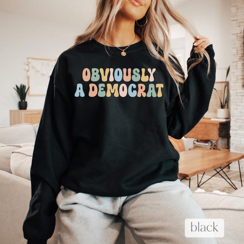May include: Black sweatshirt with the text "OBVIOUSLY A DEMOCRAT" in colorful letters.