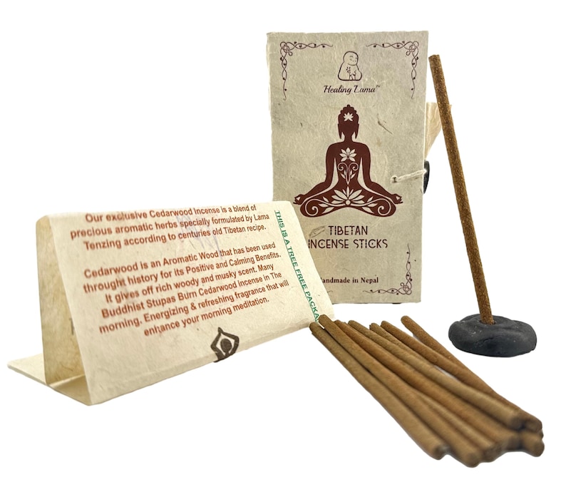 May include: A pack of Tibetan Cedarwood incense sticks with a brown paper wrapper and a small Buddha image. The text on the wrapper reads "Healing Lama" and "Tibetan Incense Sticks". The incense sticks are brown and are handmade in Nepal.