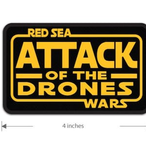 May include: A black and yellow patch with the text "RED SEA ATTACK OF THE DRONES WARS" in a Star Wars-inspired font.