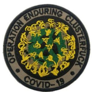 May include: A round, tan and black embroidered patch with the text "Operation Enduring Clusterfuck COVID-19" around the edge. The center of the patch features a green and yellow camouflage pattern.