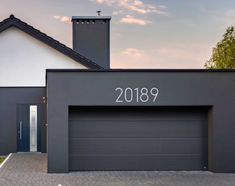 May include: A modern house with a gray garage door and a white door. The house number 20189 is displayed above the garage door.