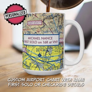 May include: White ceramic mug featuring a personalized airport chart design. The mug displays the text "MICHAEL NANCE FIRST SOLO on 16R at VNY" and includes a "PERSONALIZED" sticker. The bottom of the mug reads "CUSTOM AIRPORT CHART WITH NAME FIRST SOLO OR CHECKRIDE DETAILS."