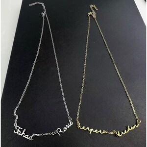 May include: Two silver necklaces with personalized names. The first necklace has the name "Fahad" and the second necklace has the name "Rose". The second necklace is gold and has the names "Harper" and "Hudson".