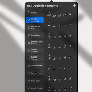 May include: A digital interface for nail designing brushes. The screen displays a menu with options like "Cursive Alphabet" and "Nail Artist Set." Cursive letter examples are shown in a variety of fonts. The top of the screen reads "Nail Designing Brushes."