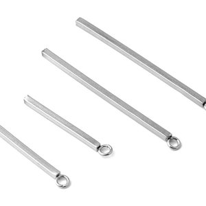 May include: Four silver metal bar pendants with a small loop at the end. The bars are different lengths.