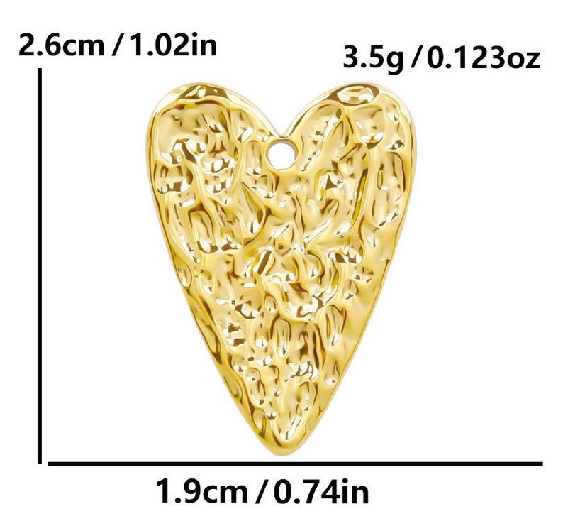 May include: A gold-colored heart-shaped charm with a textured surface. The charm measures 2.6 cm by 1.9 cm and weighs 3.5 grams.