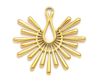 May include: A gold-colored pendant with a sunburst design. The pendant features a central teardrop shape with radiating, elongated bars. The overall design is symmetrical and has a polished finish, suitable for jewelry making.
