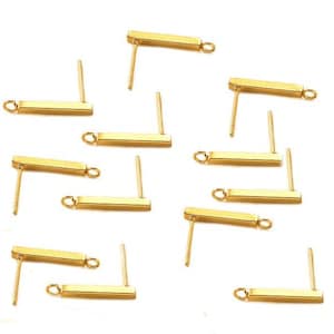 May include: Ten gold-toned earring posts with a small loop at the end of each post. The posts are designed to be used with a variety of earring charms.