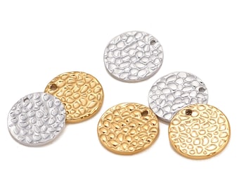 May include: Six round metal charms with a textured surface. Three charms are gold and three charms are silver. Each charm has a small hole at the top for attaching to a necklace or bracelet.