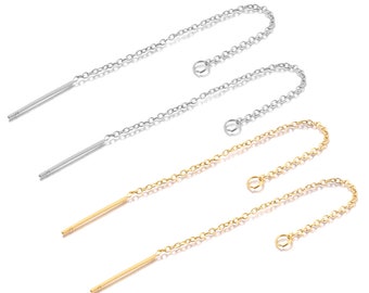 May include: Two pairs of dangle earrings with a thin, straight rod and a delicate chain. One pair is silver and the other is gold.
