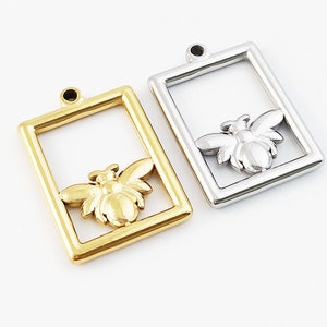 Peut inclure: Deux breloques en forme d'abeille en métal, l'une dorée et l'autre argentée, avec un cadre carré autour de l'abeille. Les breloques en forme d'abeille sont parfaites pour la fabrication de bijoux ou l'artisanat.