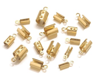 May include: An assortment of gold-coloured crimp end findings for jewellery making. The findings are in various shapes and sizes, including cylindrical and rectangular designs, with small loops for attaching to other components. The metal has a shiny finish.