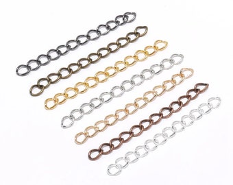 May include: Assortment of six different colored metal chains. The chains are all the same style, with oval links. The chains are arranged in a row, from left to right, in the following order: black, bronze, gold, silver, copper, and nickel.
