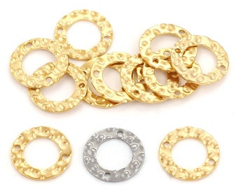 May include: A group of ten gold-colored metal rings with a hammered texture. The rings have two small holes on the top and bottom. One ring is silver-colored.