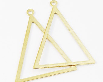 May include: Two gold triangle shaped metal charms with a loop at the top for attaching to jewelry or other crafts.