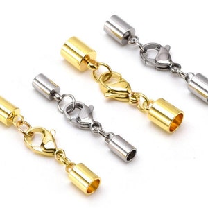 May include: Four gold and silver tone metal end caps with lobster claw clasps. The end caps are cylindrical and have a smooth finish.