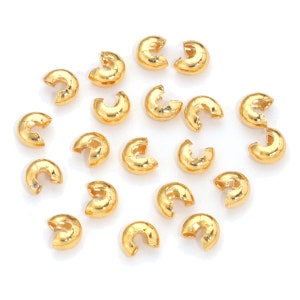 May include: A collection of gold-toned metal jump rings, ideal for jewelry making and crafting projects.