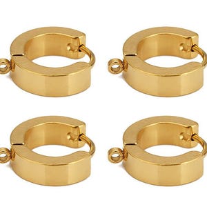 May include: Four gold-toned hoop earring components arranged in a grid. Each circular hoop features a smooth, polished finish and includes a small, integrated loop on the outer edge for attaching charms or other decorative jewellery elements.