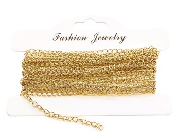May include: A roll of gold-colored chain, displayed on a white card with the text "Fashion Jewelry".
