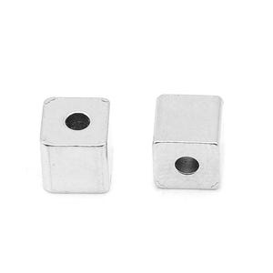 May include: Two silver square beads with a hole in the centre. The beads are smooth and have a shiny finish.